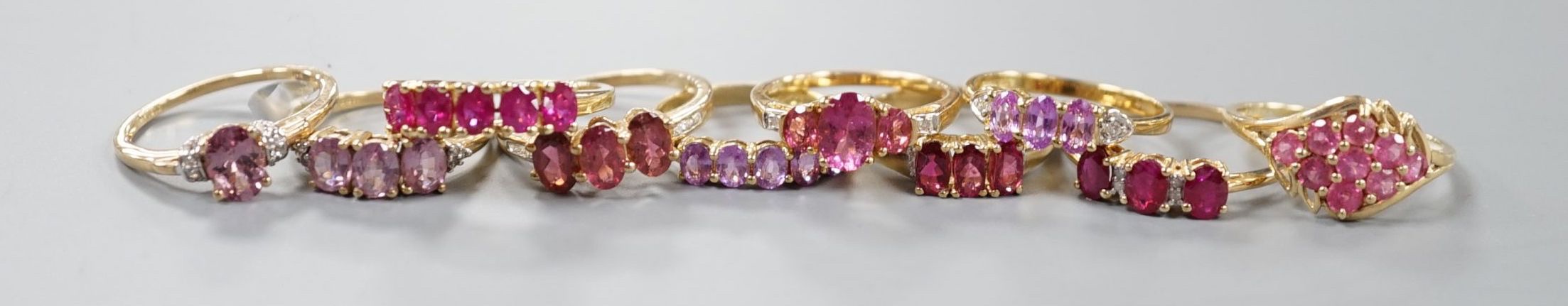 Ten assorted modern 9ct and gem set dress rings including rubellite, gross weight 18.8 grams.